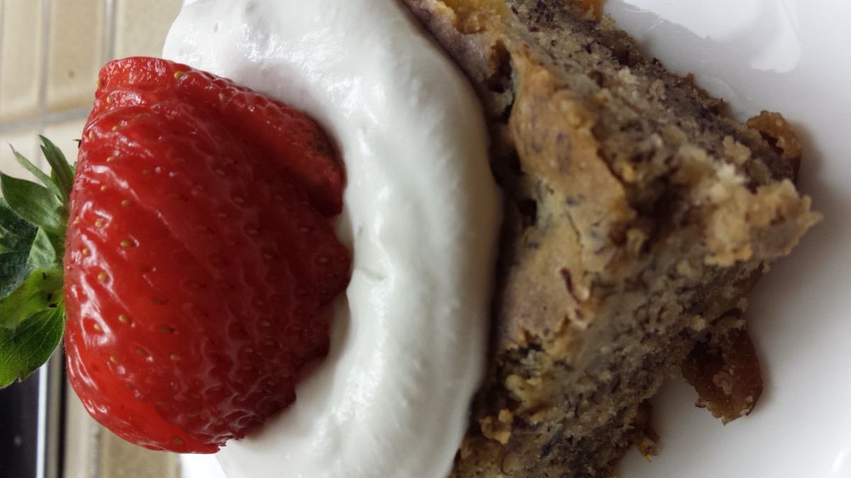 Walnut cake slice with whipped cream and strawberry