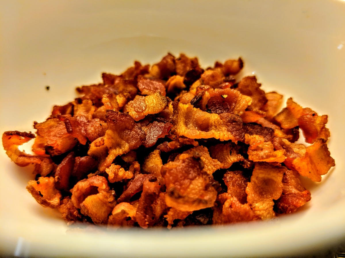 Crispy fried bacon bits in a bowl