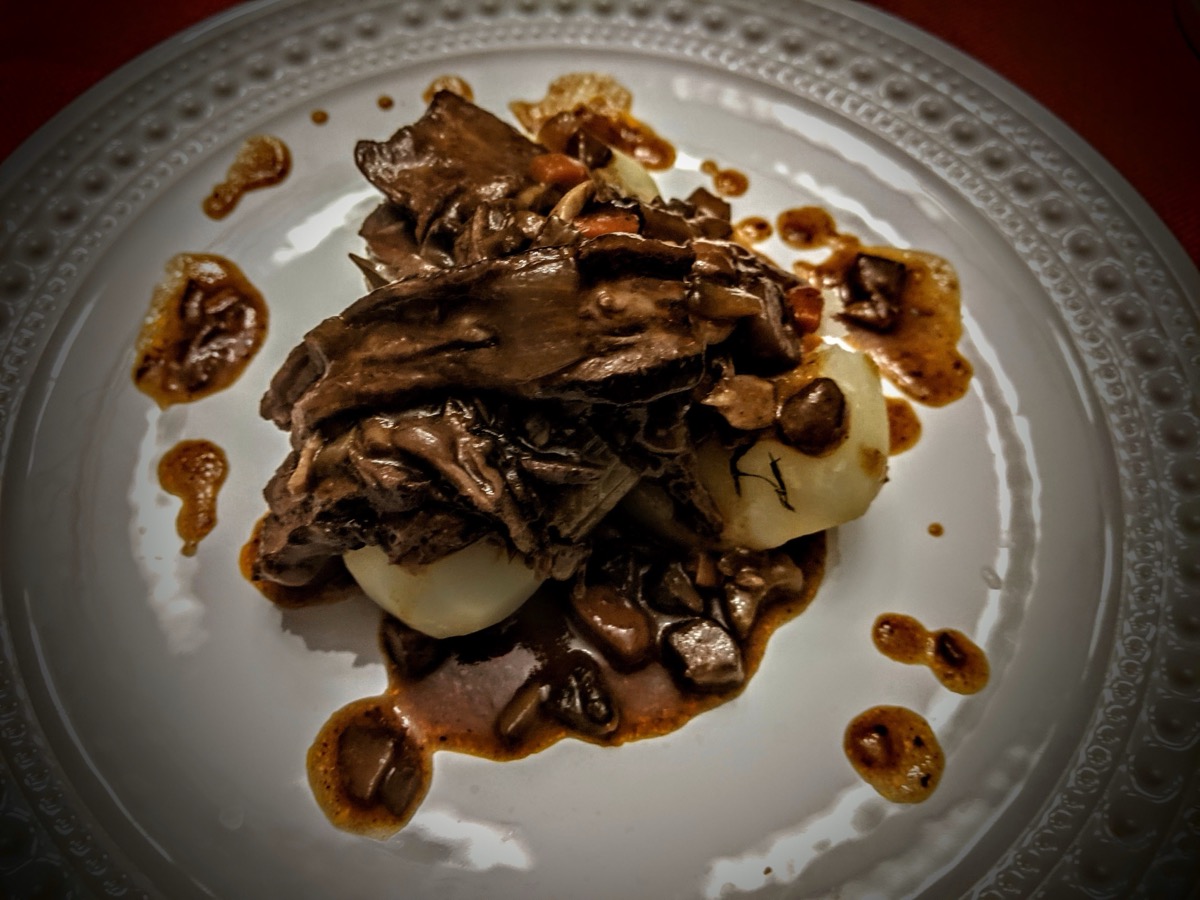 Braised beef with mushrooms over mashed potato