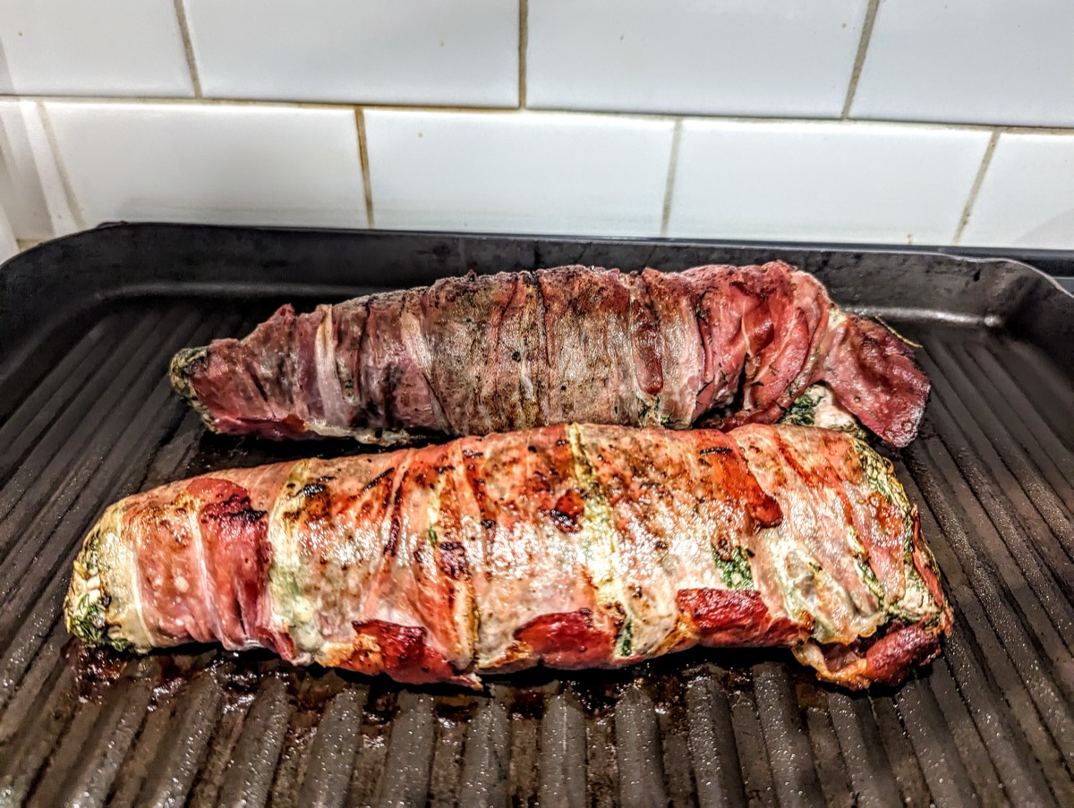 Bacon-wrapped beef roulades on grill