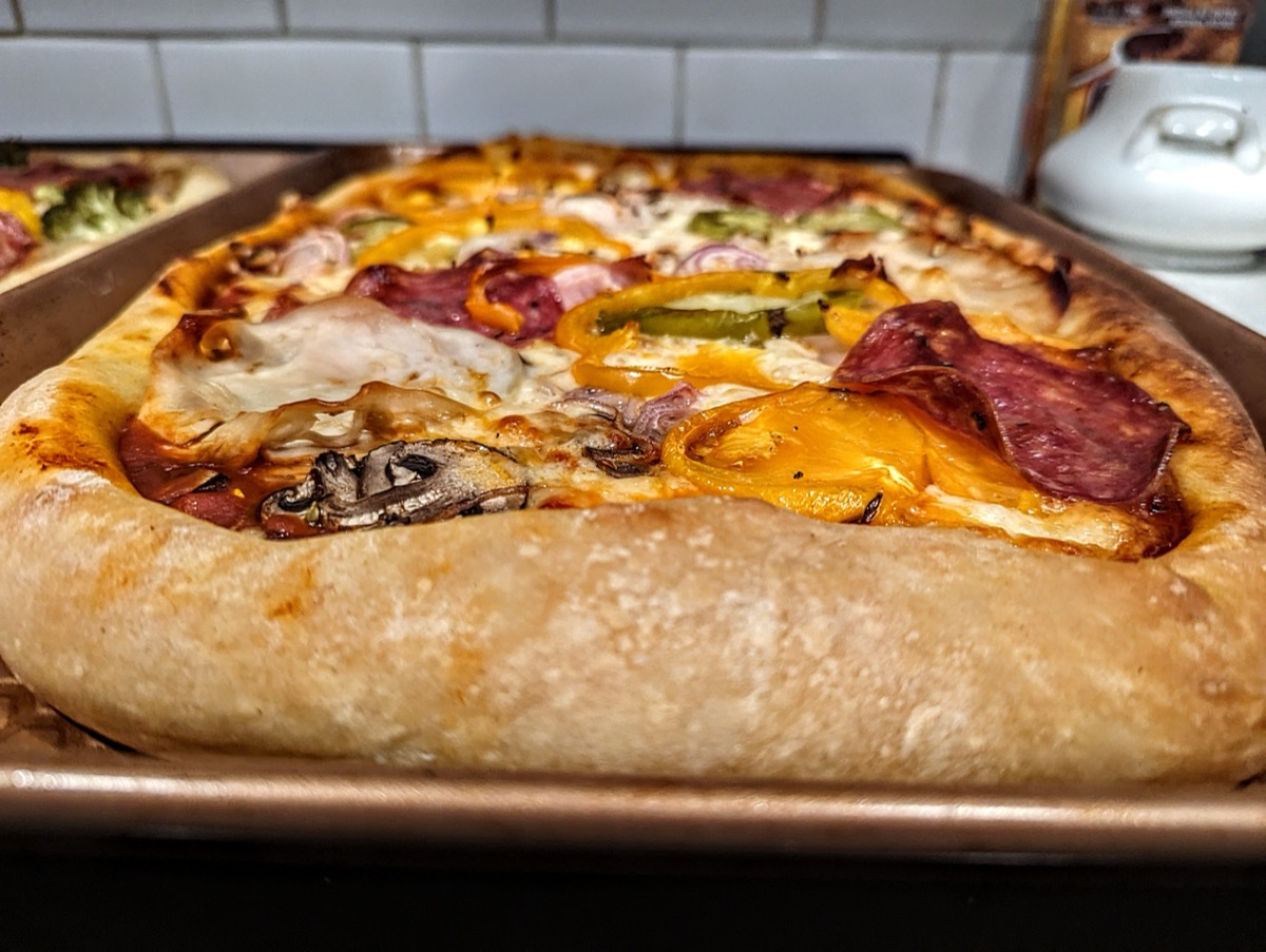 Homemade pizza with salami and peppers