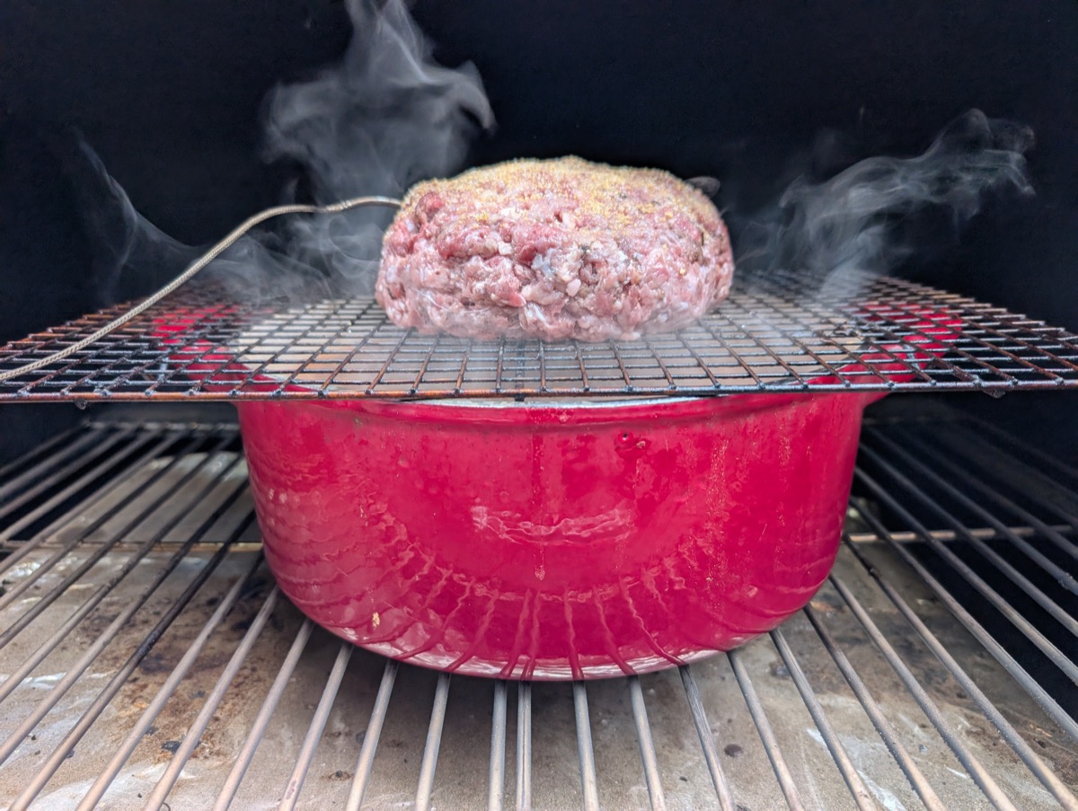 Meatloaf on smoker with smoke rising