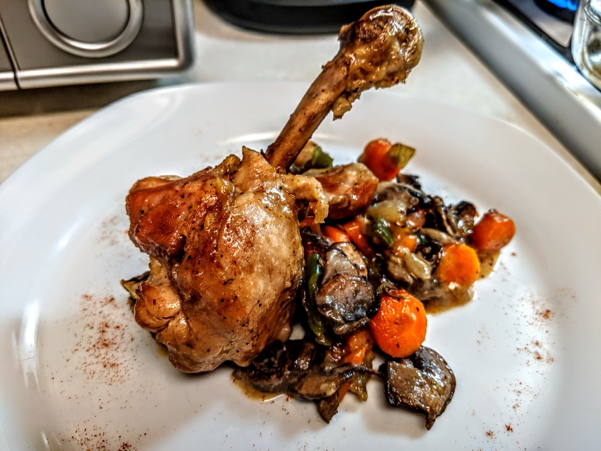 Roasted chicken leg with mushrooms and carrots